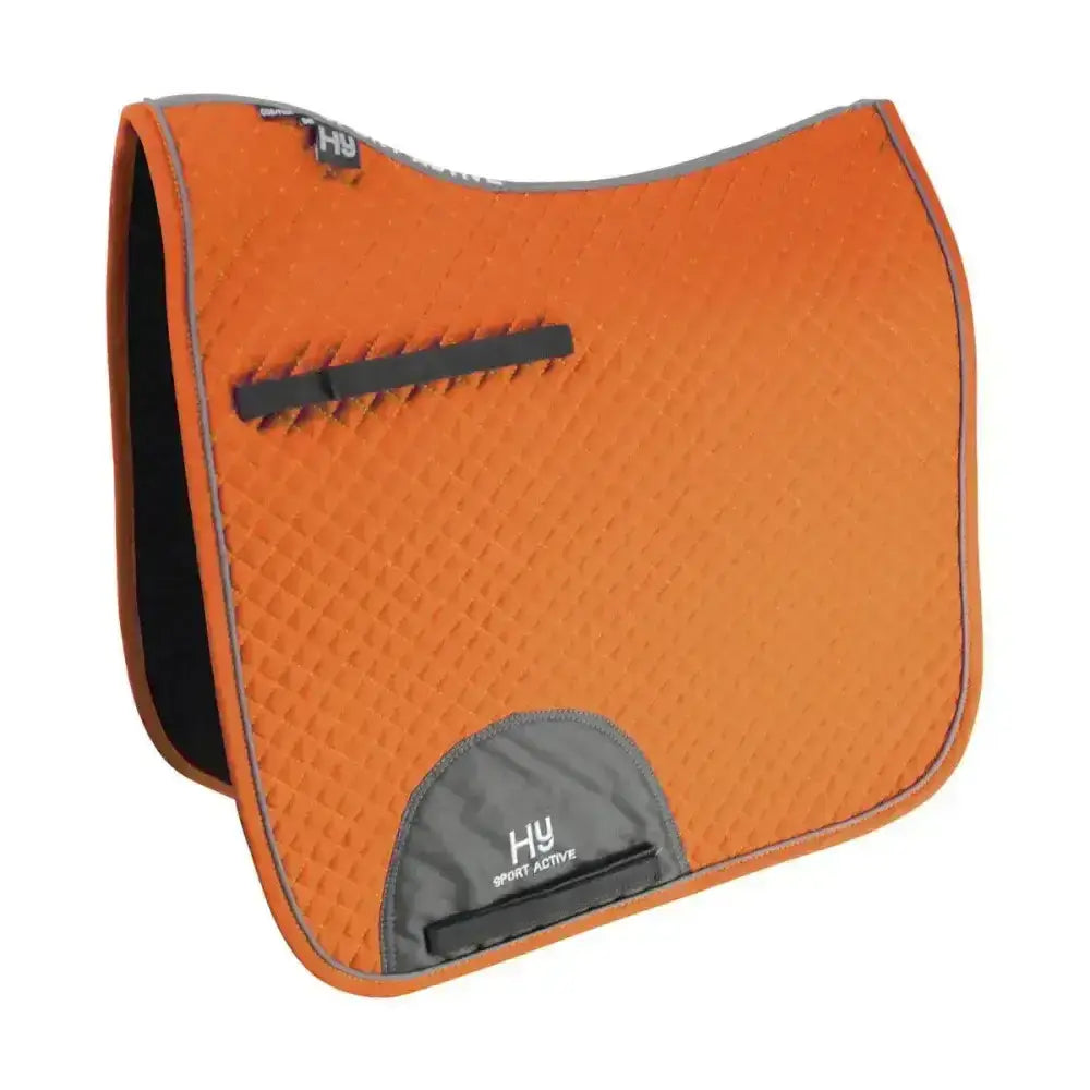 Orange textured hy sport active dressage saddle pad with black trim and gray branded patch featuring signature hywither cut