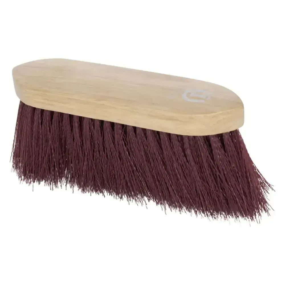 A sturdy imperial riding dandy brush long with a light wooden handle and dense maroon bristles for grooming horses