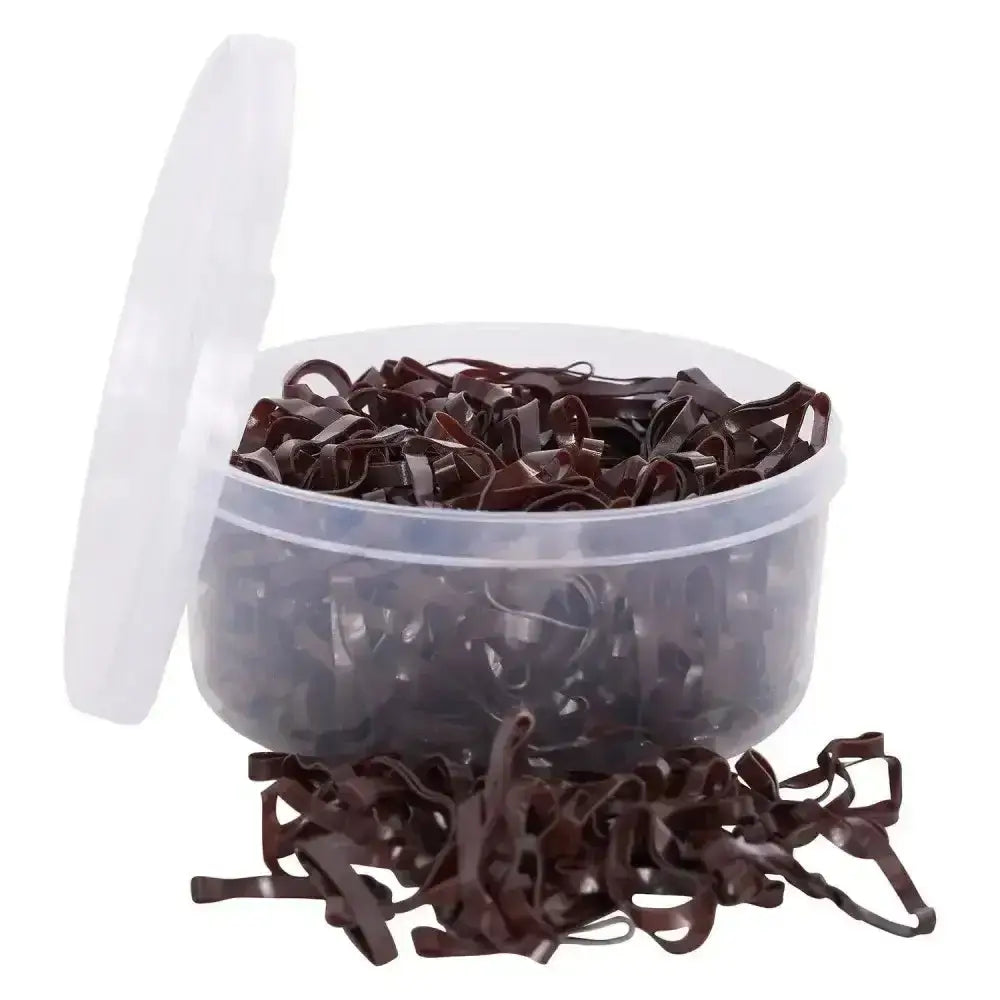 A clear container filled with dark brown imperial riding plaiting silicone bands soft spilling onto the surface