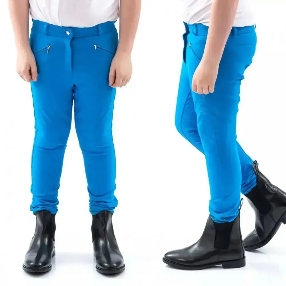 Bright blue john whitaker miami kids breeches with zippered pockets and full silicone seat for riding comfort