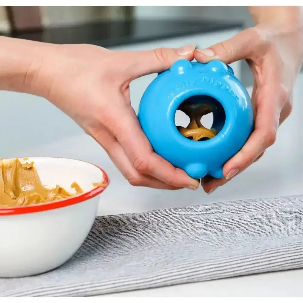 Blue silicone jolly pets jolly dipper treat dispenser with central hole and raised bumps made of special material super tough