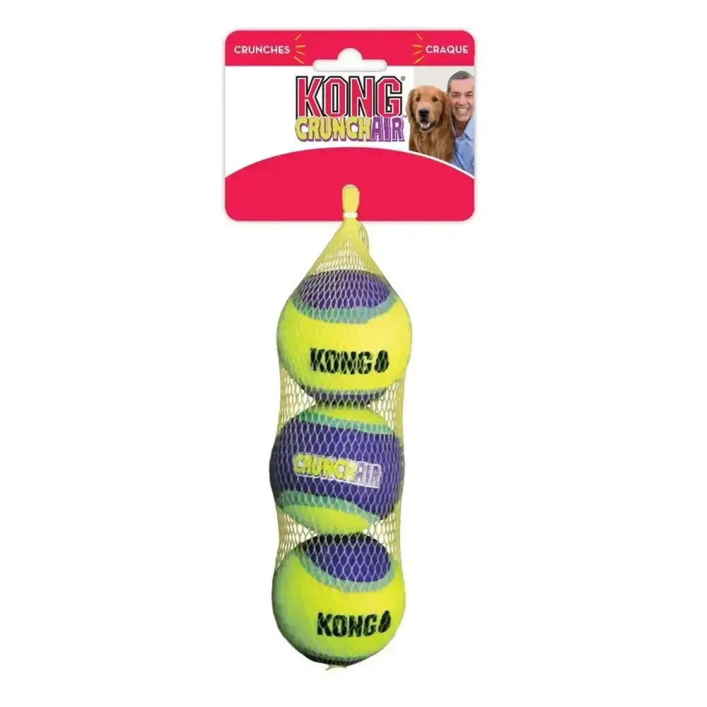 Three bright yellow and purple kong crunchair balls tennis balls nestled in a mesh bag for durable play