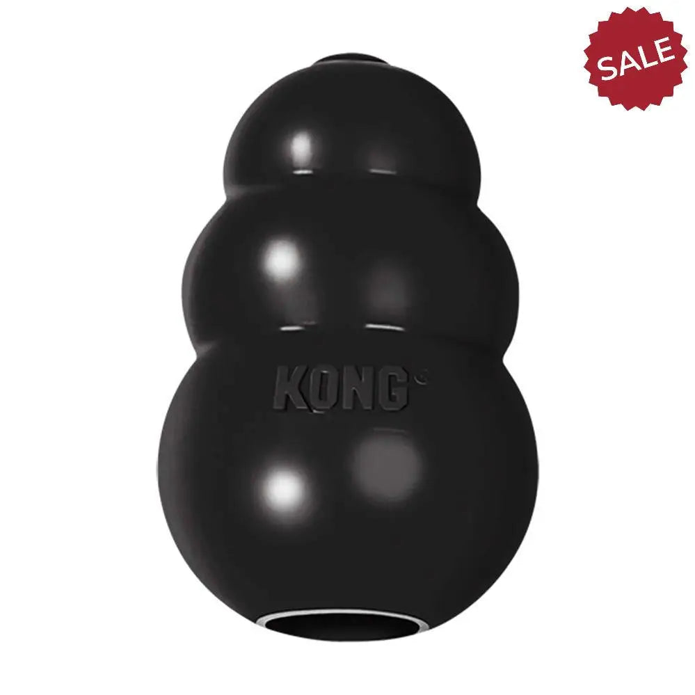 Black kong extreme medium dog toy with glossy durable rubber and segmented hourglass shape for tough chewers