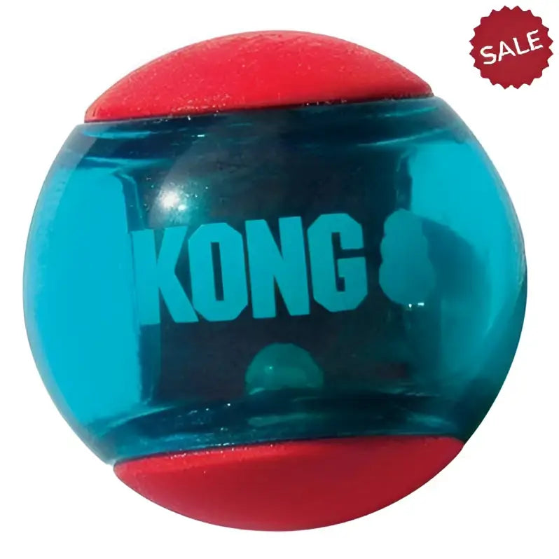 Transparent teal kong squeezz action ball with red rubber caps and visible green internal ball for dogs
