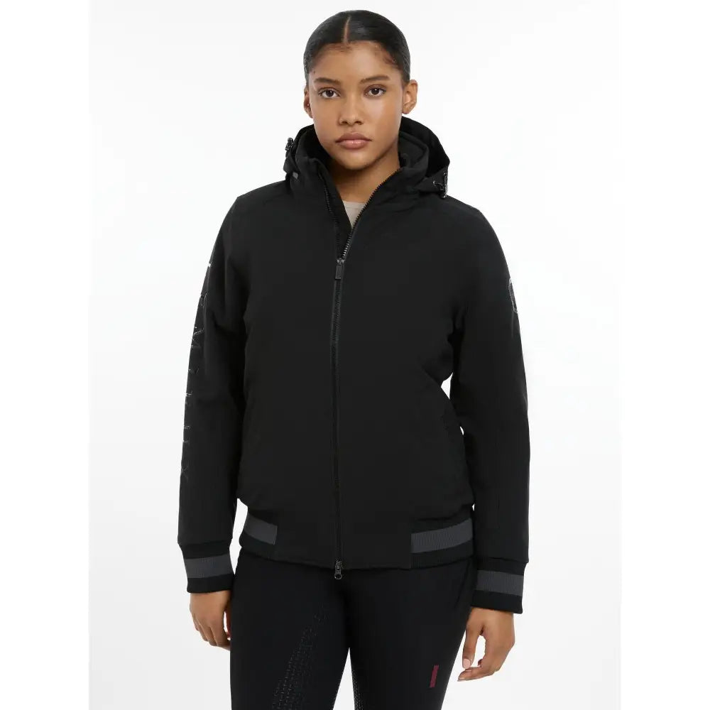 Black hooded zip-up ladies team jacket with subtle gray trim on cuffs and waistband for a sleek modern look