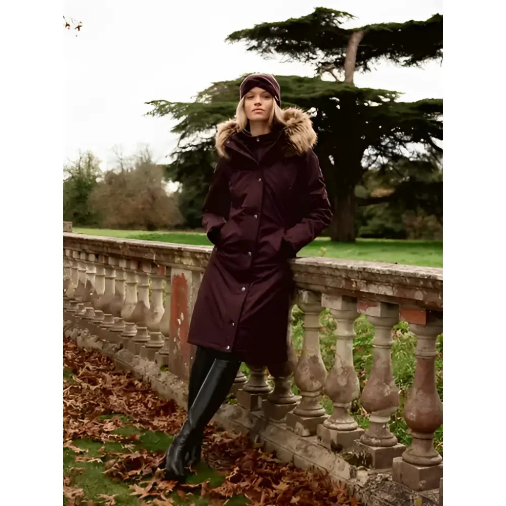 Dark maroon lemieux anya waterproof riding coat with fur-lined hood and button closures perfect for wet weather