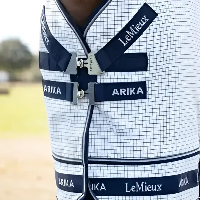 White and navy blue checkered lemieux arika field rug white with black straps and branding for outdoor use