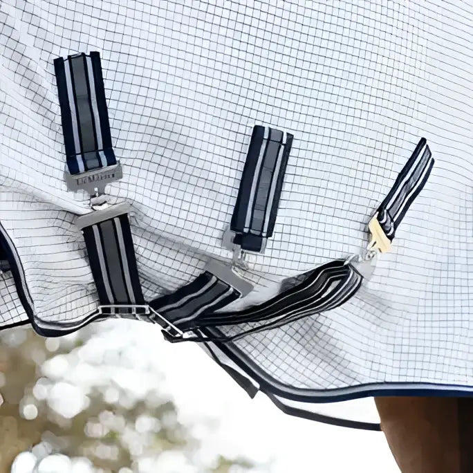 White and navy checkered lemieux arika field rug with black and white striped straps and silver buckles field rug white