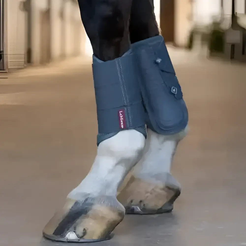 Blue lemieux arika mesh brushing boots petrol with a red brand tag for horse leg protection and support