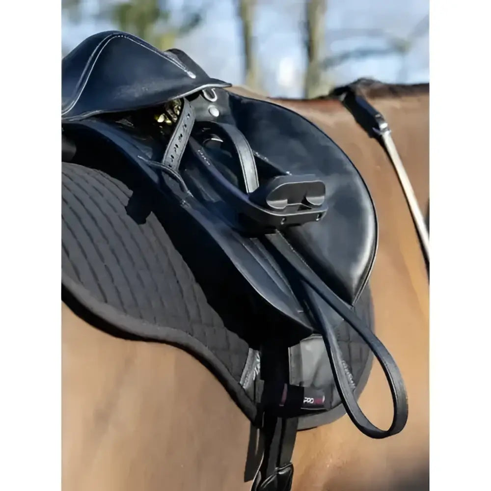 Black leather english saddle with quilted pad and adjustable straps featuring sophisticated lemieux style and arika stirrup leather