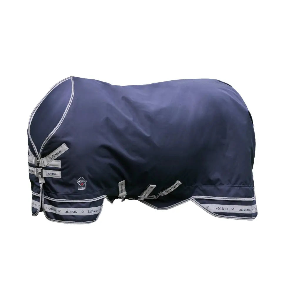 Navy blue waterproof lemieux arika storm-tek horse blanket with silver trim and branded straps, innovation gold award winner
