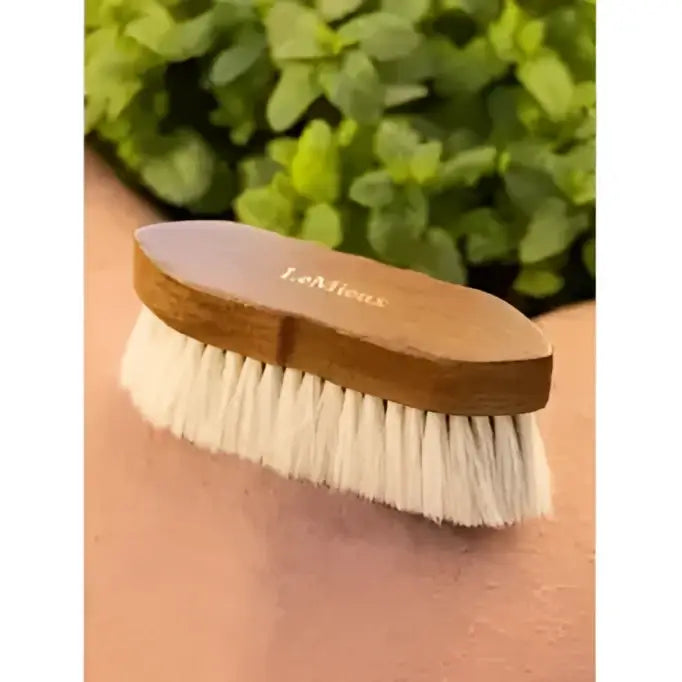 A light brown wooden lemieux artisan soft finishing brush with white anti-static bristle finishing for smooth grooming