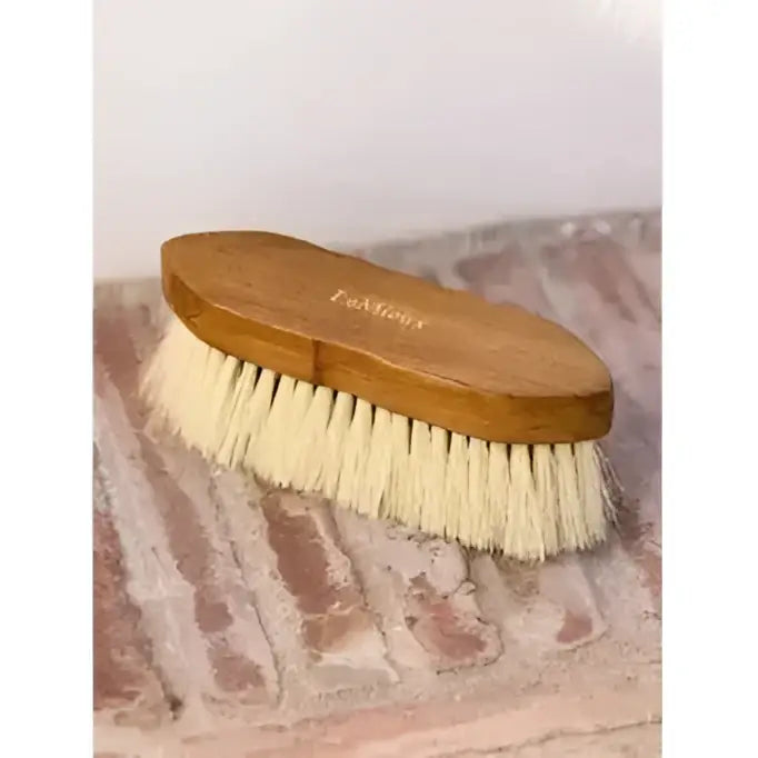 A lemieux artisan soft finishing brush with light brown wooden handle and dense creamy white anti-static bristles