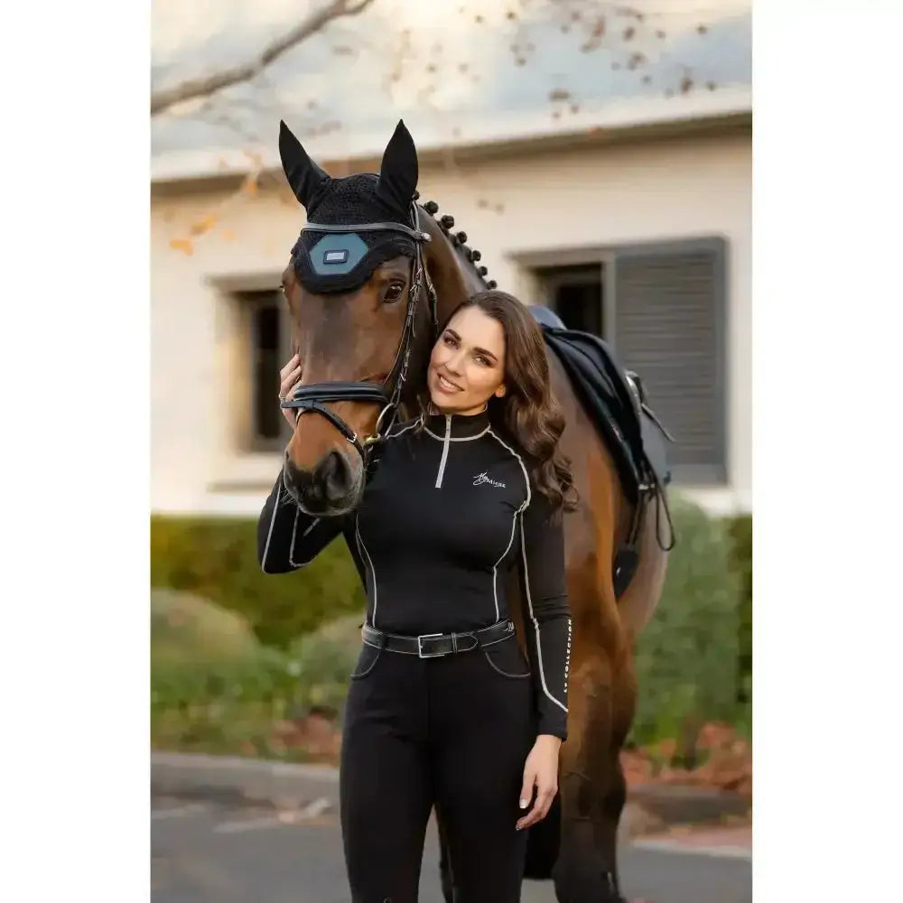 Black lemieux base layer riding apparel with white piping silver zipper and breeza logo on chest rider base gear