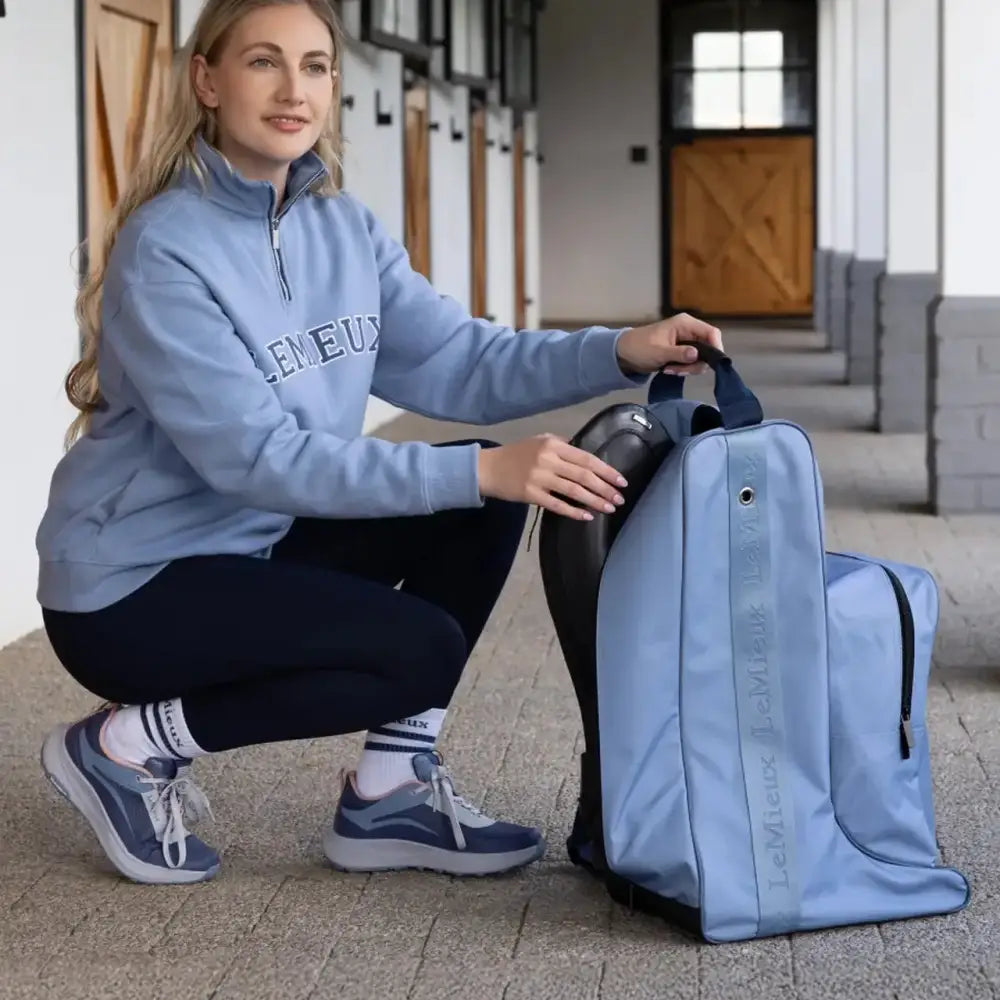 Light blue lemieux boot bag with black accents made of waterproof nylon for riding hat and boots storage