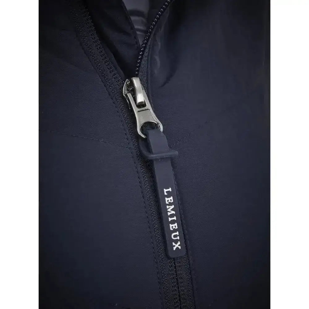 Black zipper pull with lemieux branding on dark navy fabric of lemieux brioney hybrid jacket for versatile wear