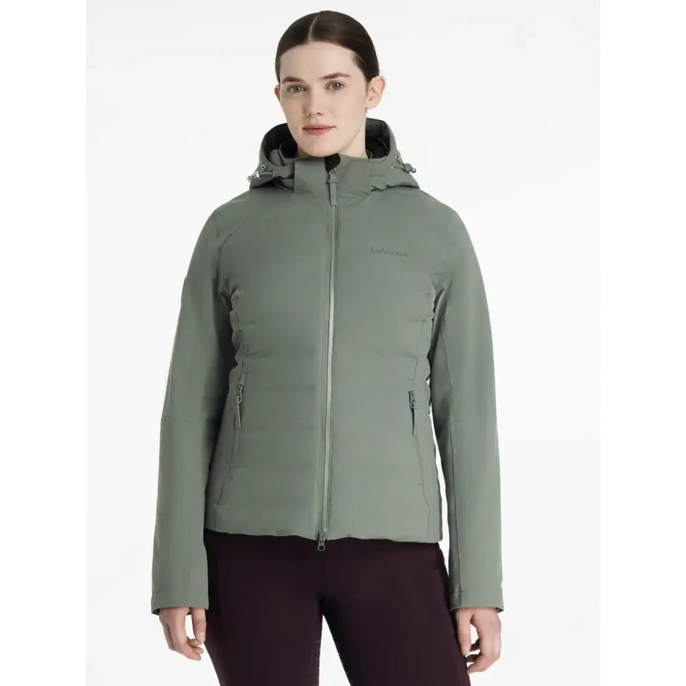 A sleek olive green lemieux brooke waterproof insulated hybrid jacket rosemary with hood and front zipper for hiking