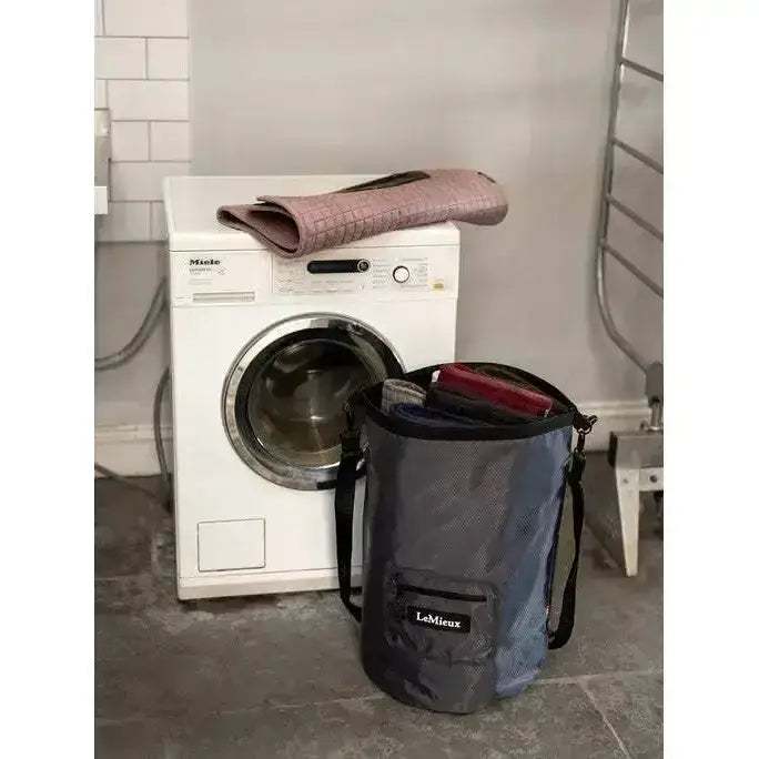 Dark gray mesh versatile laundry bag with black straps and lemieux carry label perfect for dirty boots storage
