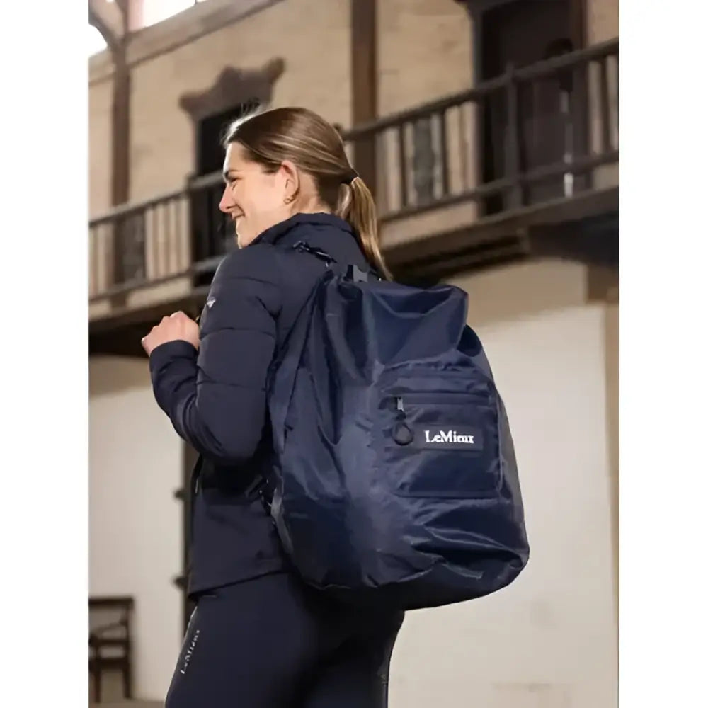 Navy blue lemieux carry all backpack with front pocket and subtle logo perfect for equestrian use