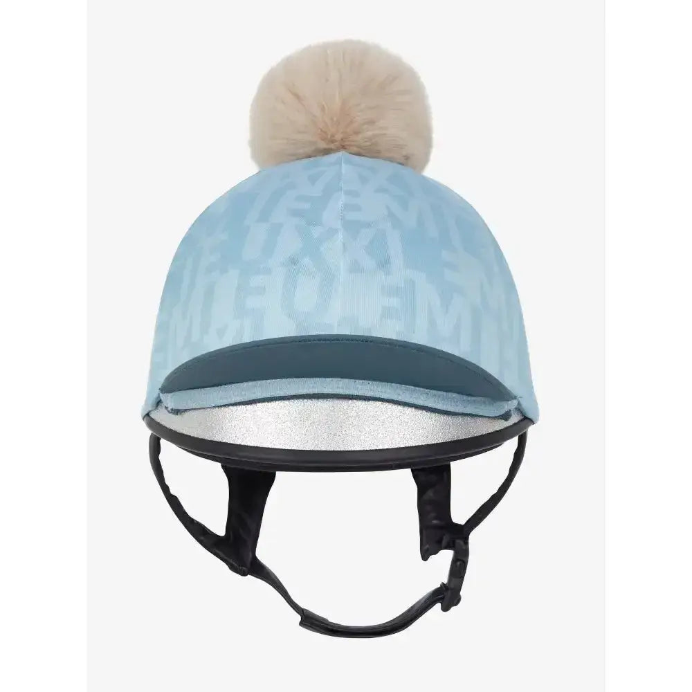Light blue lemieux casey hat silk glacier with subtle pattern dark teal band and beige pom-pom on top