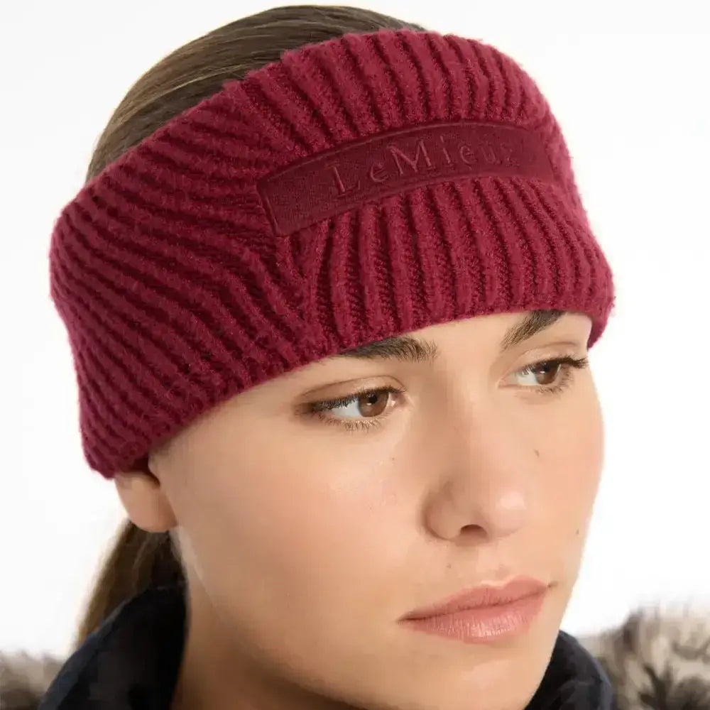 A maroon ribbed knit lemieux clara cable headband with a subtle brand patch perfect for cozy wear