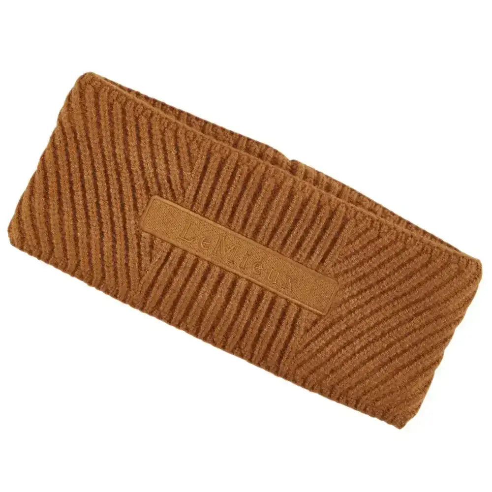 Brown corduroy lemieux clara cable headband with subtle embossed logo patch in cable headband ginger color