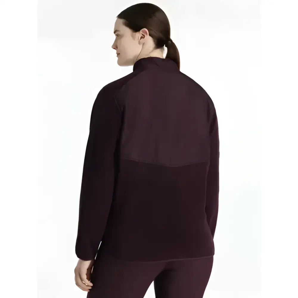 Dark purple lemieux clara hybrid fleece jacket with high collar and contrasting fabric panels for athletic use