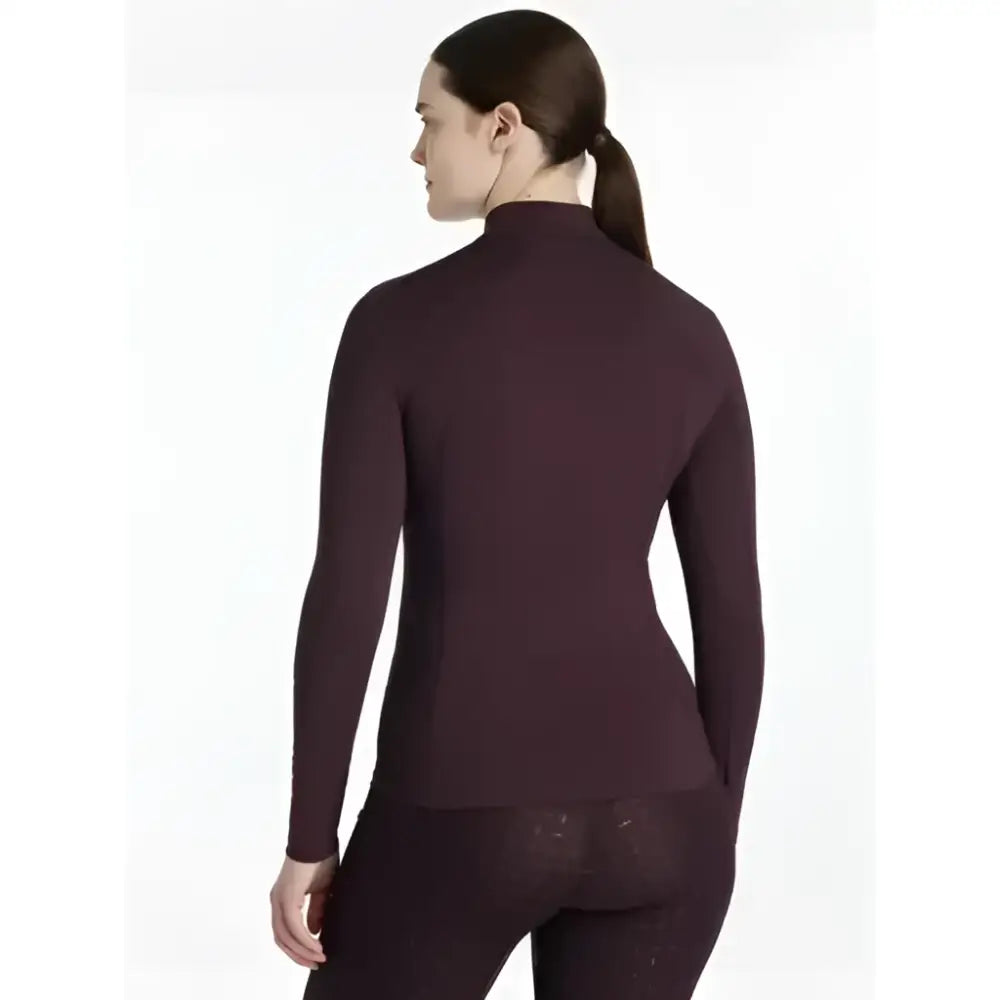 A sleek dark burgundy lemieux classique base layer long sleeve top with a high neck and smooth form fitting fabric