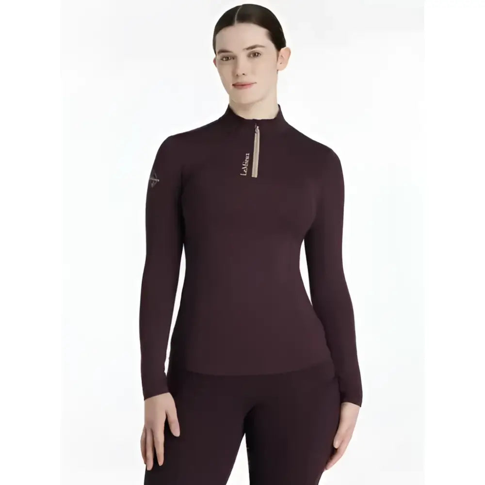 A maroon lemieux classique base long-sleeved damson layer with high collar zipper and subtle chest branding