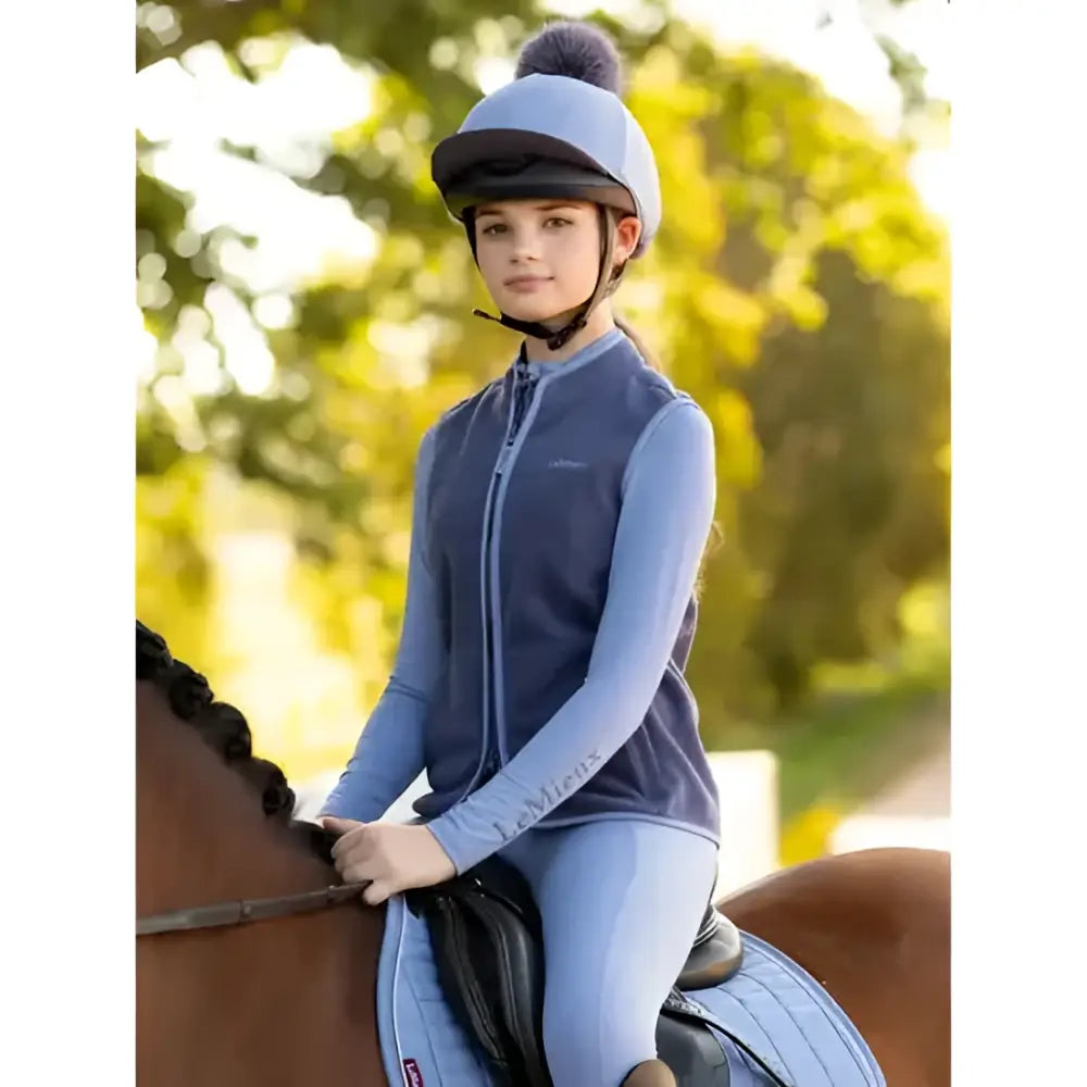 Blue equestrian helmet lemieux classique pom with silk powder blue finish and soft faux fur pom on top