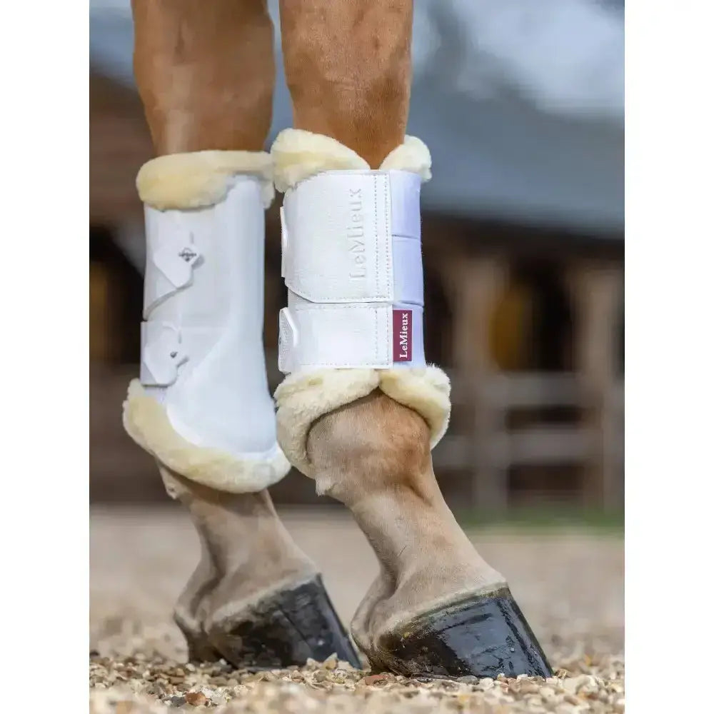 White lemieux fleece edged mesh brushing boot with cream fleece lining and red brand label