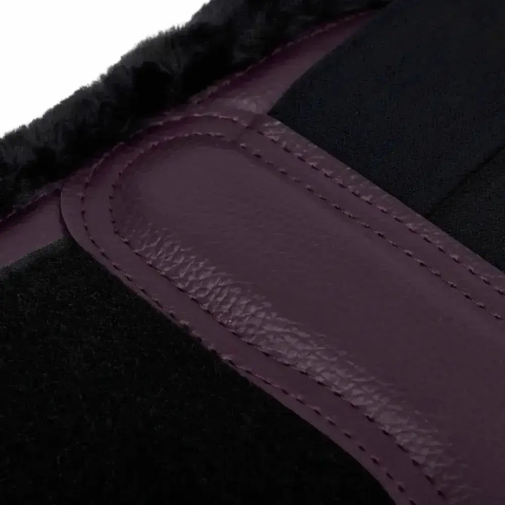 A plush black lemieux fleece lined brushing boot with purple leather strap and precise stitching in brushing boots fig