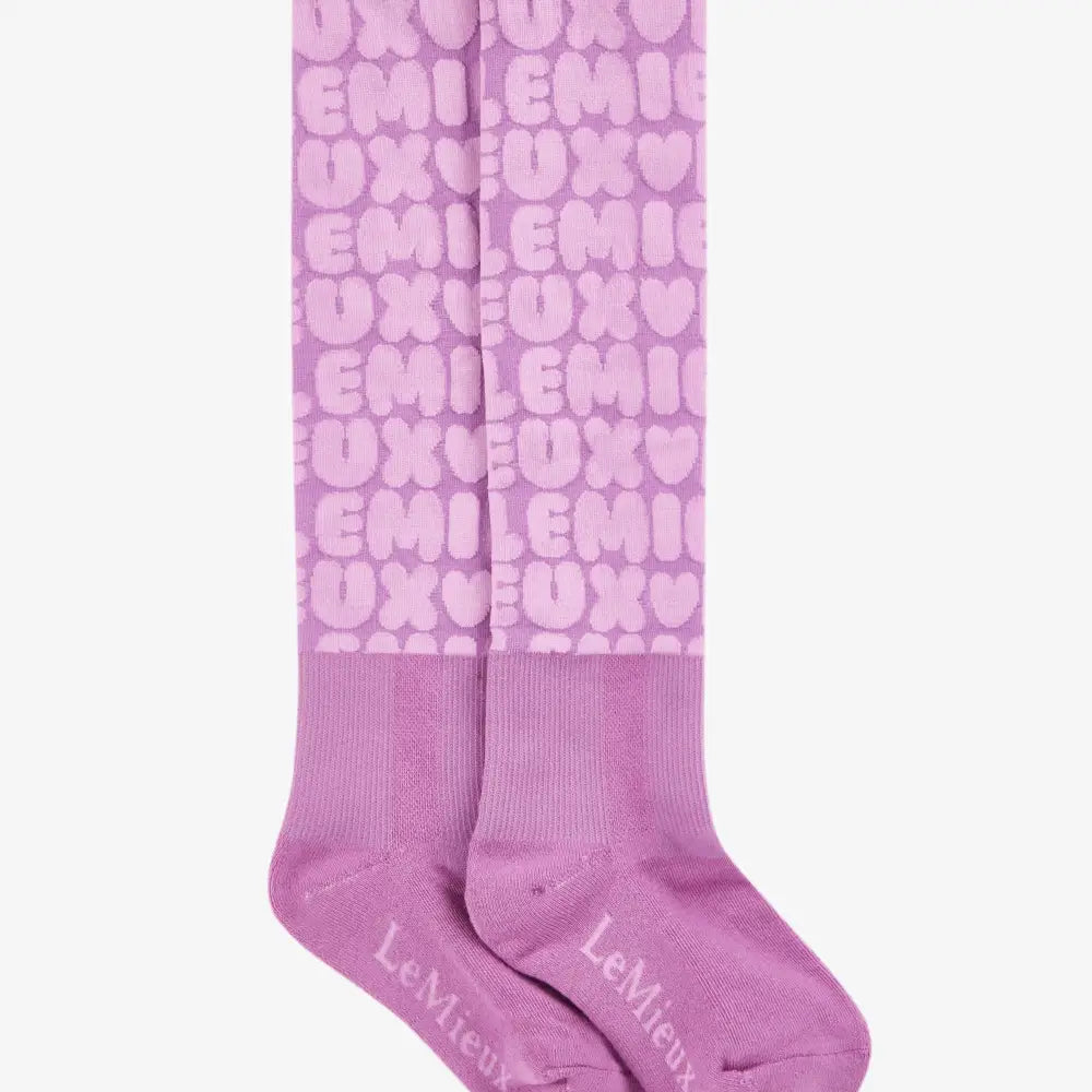 Pair of lavender lemieux footsie socks with bubble font fondant pattern and repeating emiux hearts design