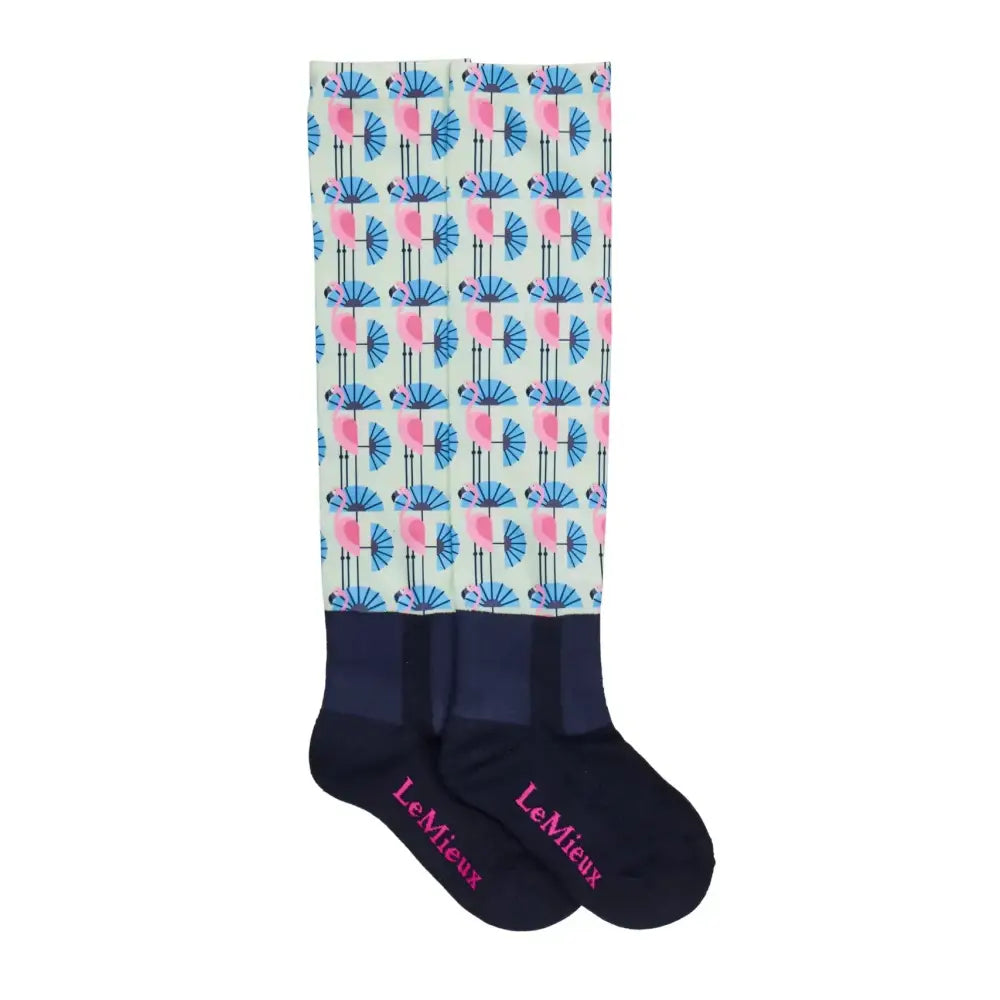 A pair of lemieux footsie socks flamingo with pink flamingos holding blue fans on mint background with navy cuffs