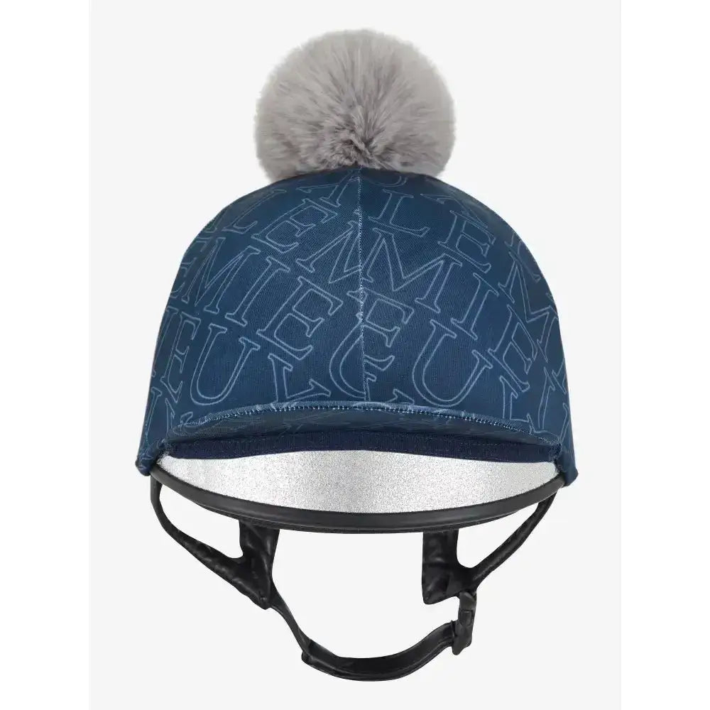Navy blue lemieux frieda hat silk with silver lettering and gray faux fur pom-pom on top