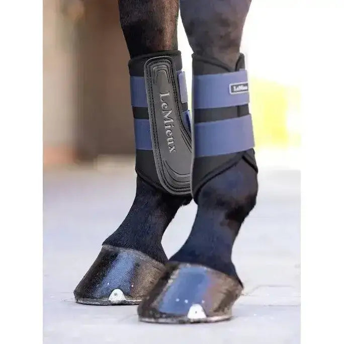 Black and gray lemieux grafter brushing boot with adjustable straps made for durability and protection on horse legs