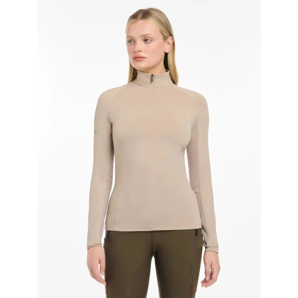 Beige long-sleeved high neck lemieux halle lightweight base layer almond with zipper at collar