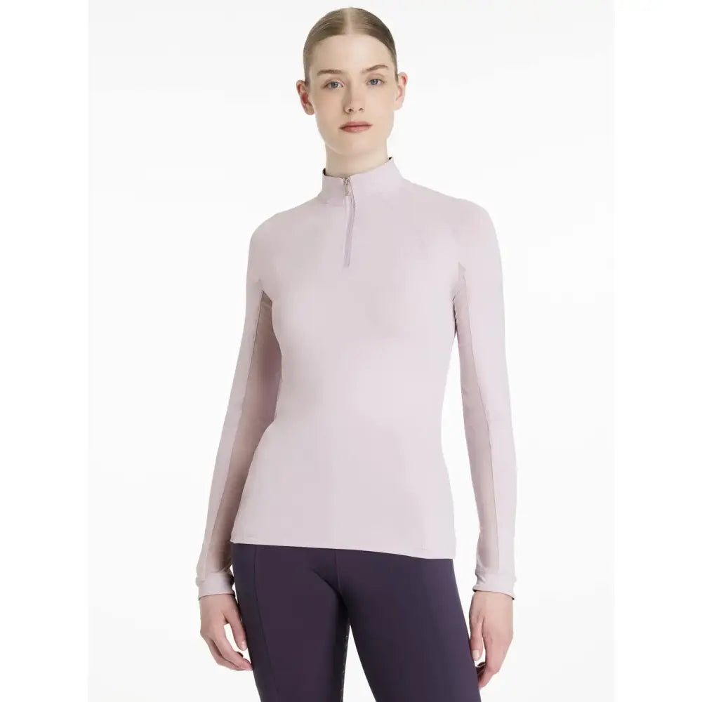 A soft lavender lemieux halle lightweight long-sleeved base layer with high collar and quarter-zip closure