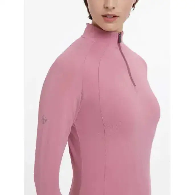 A soft pink lemieux halle lightweight base layer peony with long sleeves high collar and zipper detail