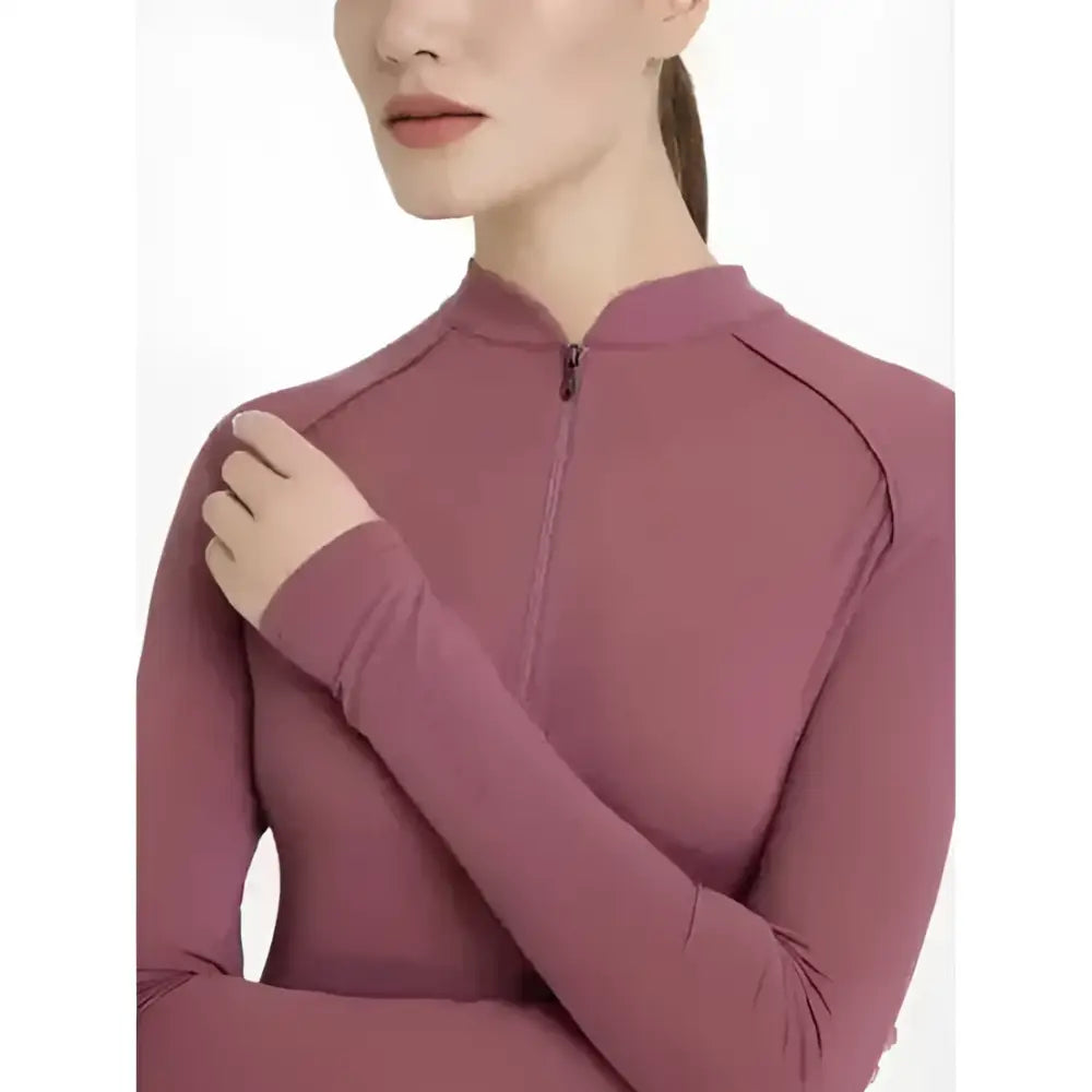 A mauve lemieux heyden lightweight base layer rosewood with a high collar and quarter-zip long sleeves