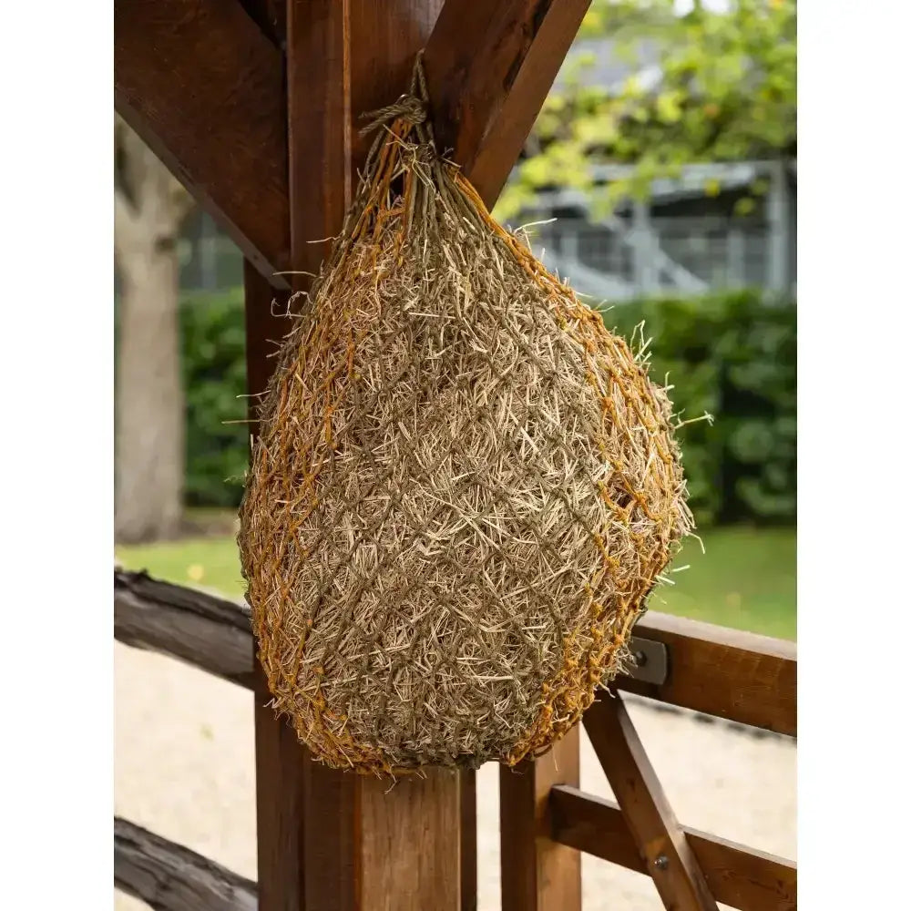A rustic lemieux hippo haynet alpine made of natural straw and dried grasses for feeding hay to horses