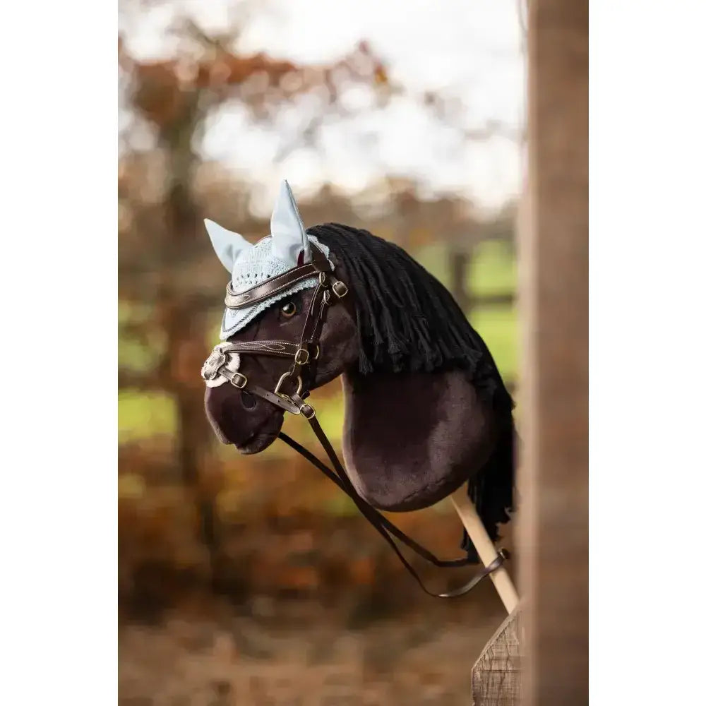 Black plush lemieux hobby horse freya head with light blue lace ear cover and brown leather bridle