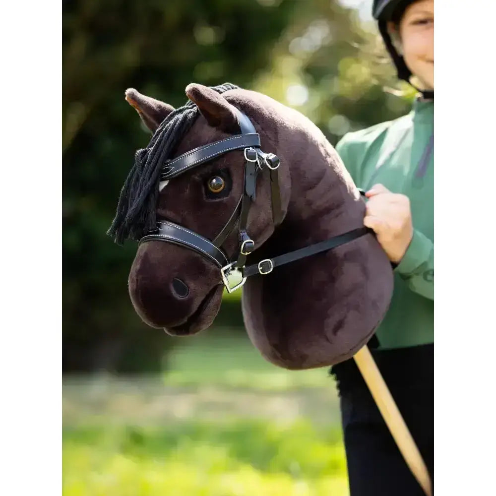 A plush dark brown lemieux hobby horse freya head with black braided mane and leather bridle for kids play