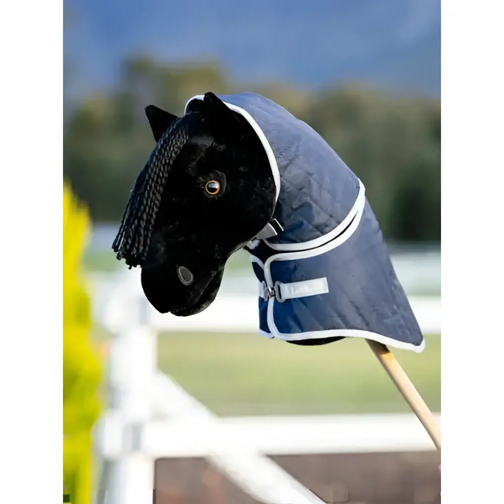 Black plush lemieux hobby horse head with navy stable rug featuring white trim and silver buckle perfect for horse care