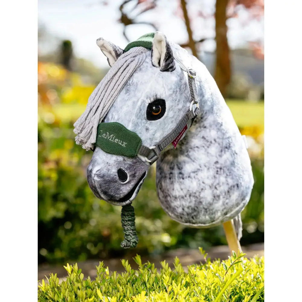 A plush gray dapple lemieux hobby horse head with a green vogue headcollar embroidered with lemieux