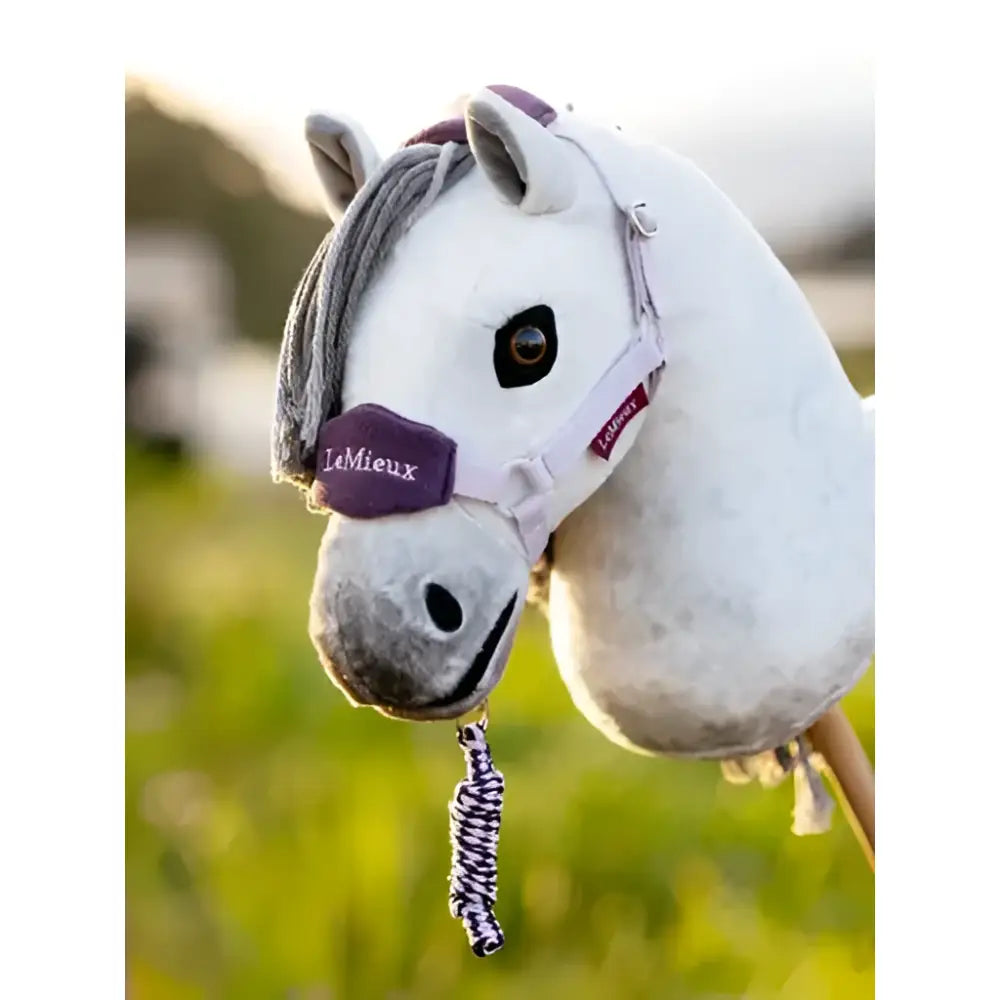 White plush lemieux hobby horse with gray mane, purple poll strap, and lilac leadrope with braided tassel