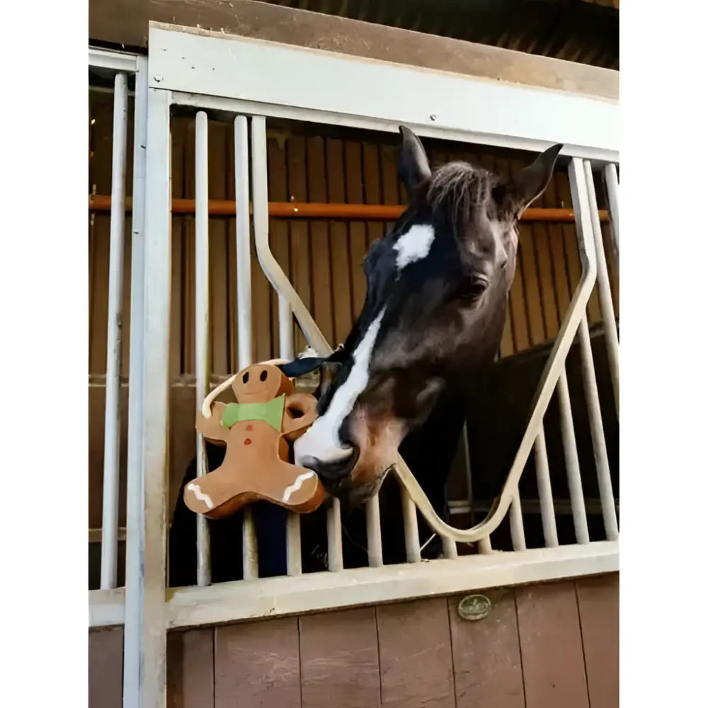 A brown lemieux horse toy gingerbread shaped like a gingerbread man with green icing and white trim details