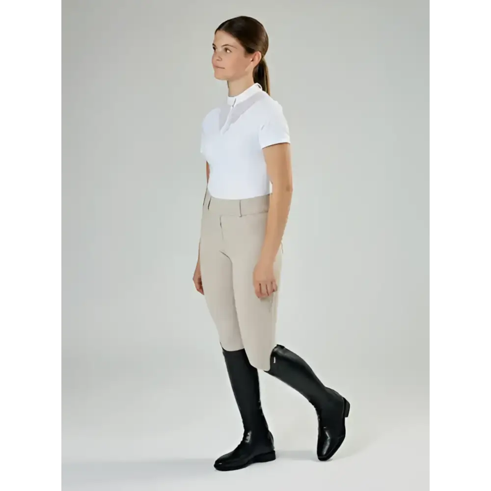 Beige equestrian riding pants with fitted waistband and side seam detail paired with lemieux junior field riding boot black