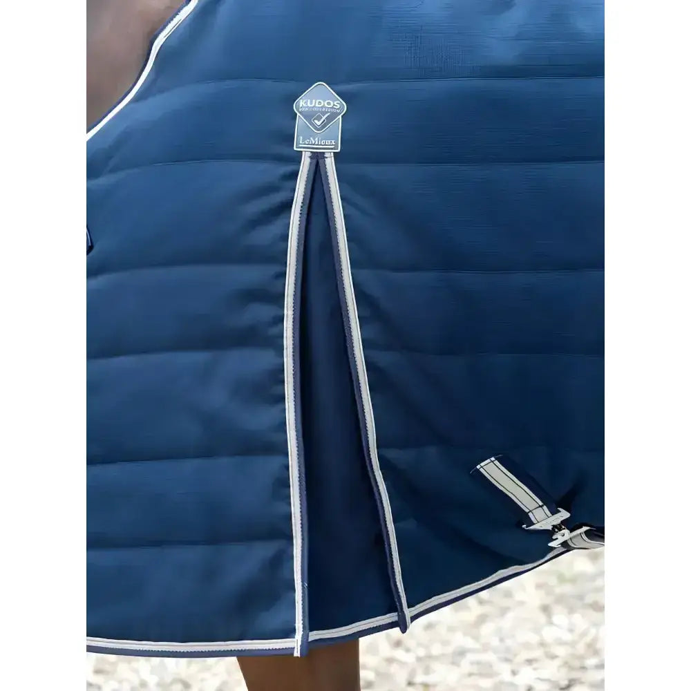 Navy blue quilted stable rug 50g with white trim and lemieux kudos stable brand tag for horses
