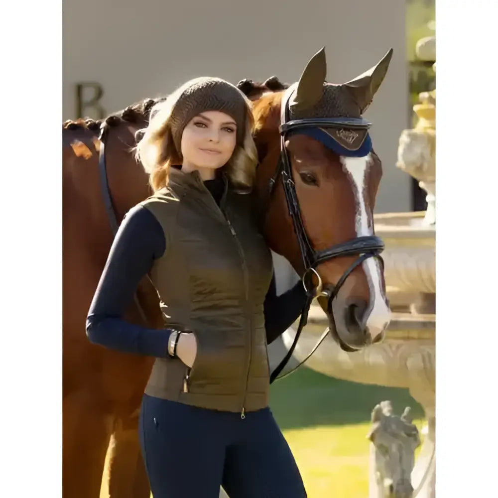 Olive green quilted vest with high collar and front zipper shown with lemieux lila headband alpine accessory